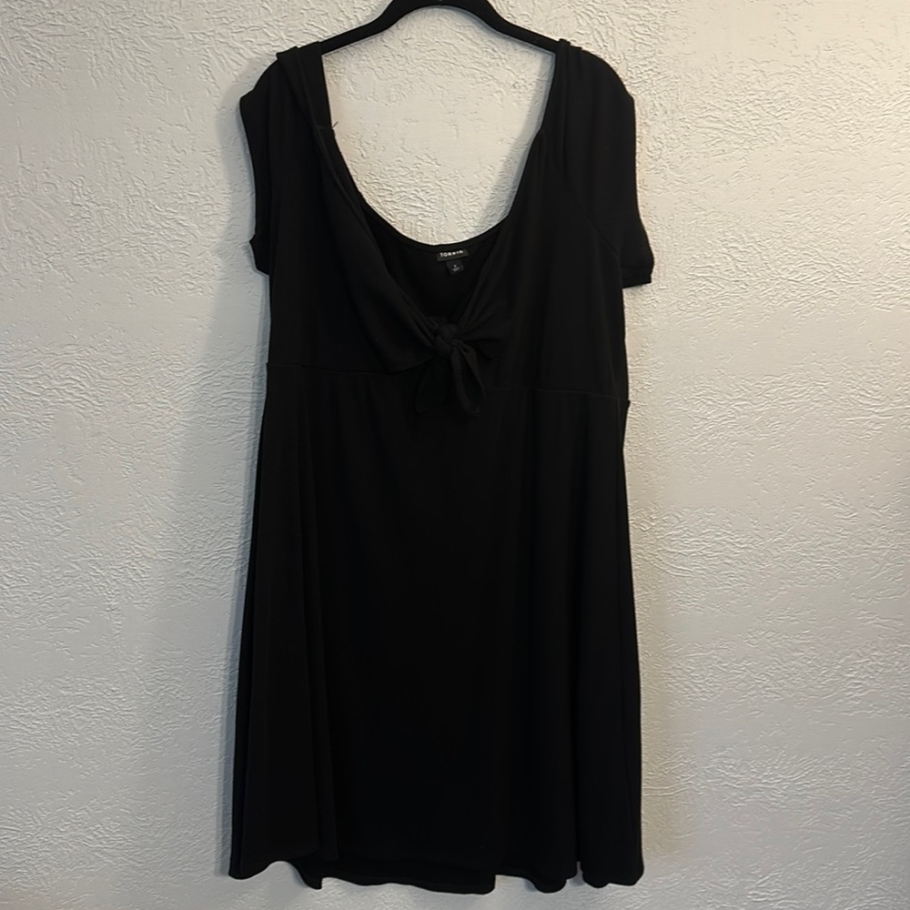 Black dress with front tie.  Polyester/ rayon blend is very comfortable.